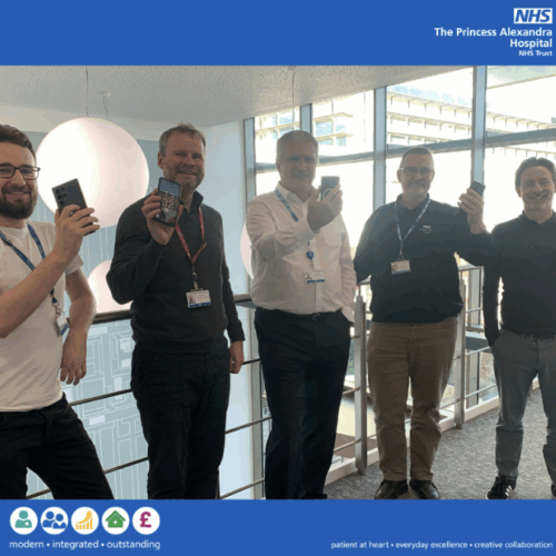 IT team at The Princess Alexandra Hospital NHS Trust (PAHT), stand holding their mobile devices.
