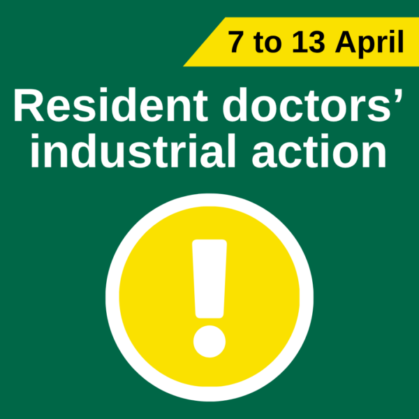 Green background poster announcing “Resident doctors’ industrial action,” with the dates “7 to 13 April” in a yellow banner at the top. A large yellow warning symbol with an exclamation mark appears below the text.